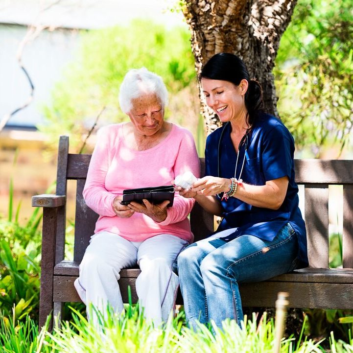 A younger woman helps an older woman.